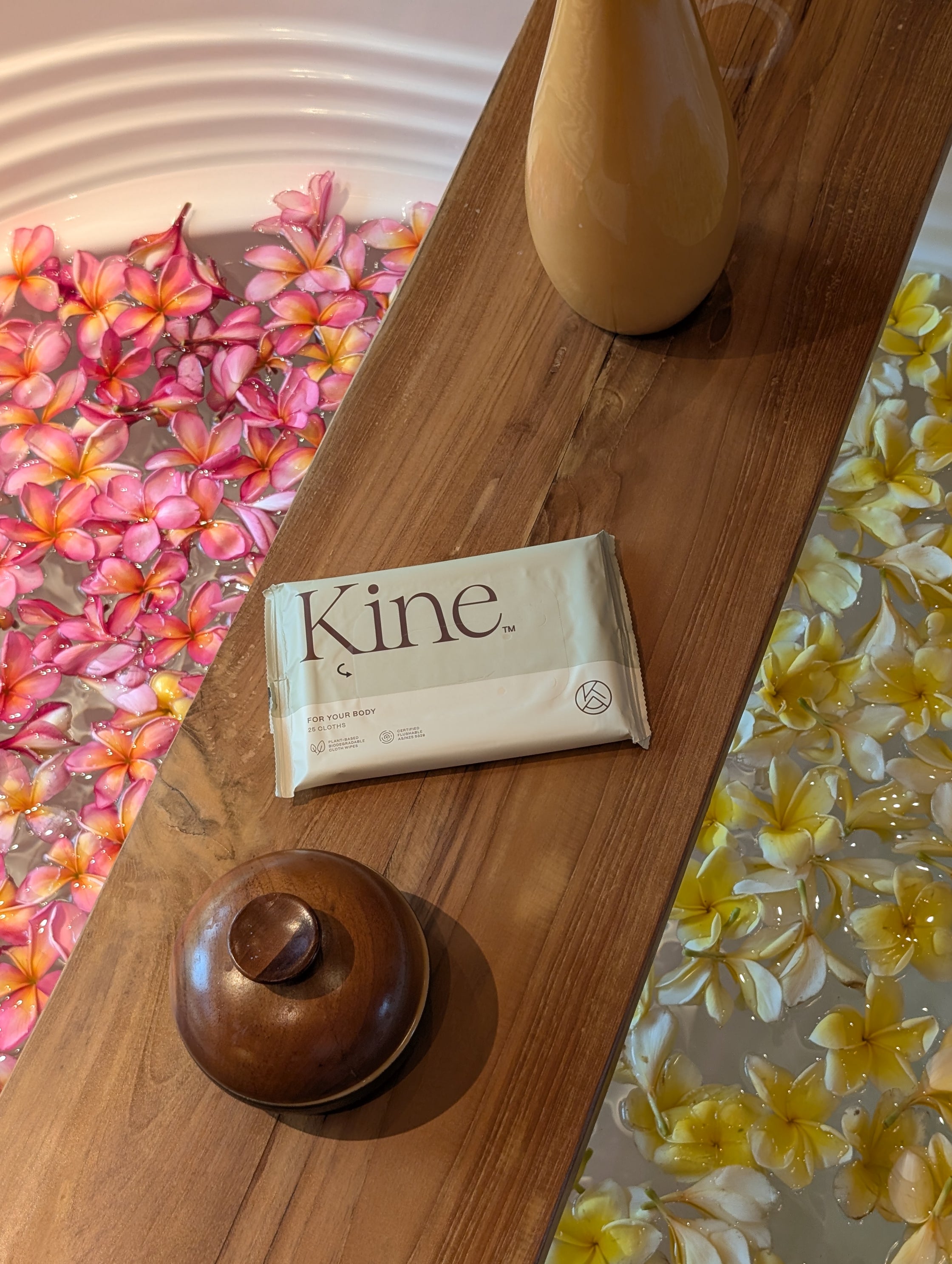 Kine bar of soap on a wooden surface with floral backgrounds